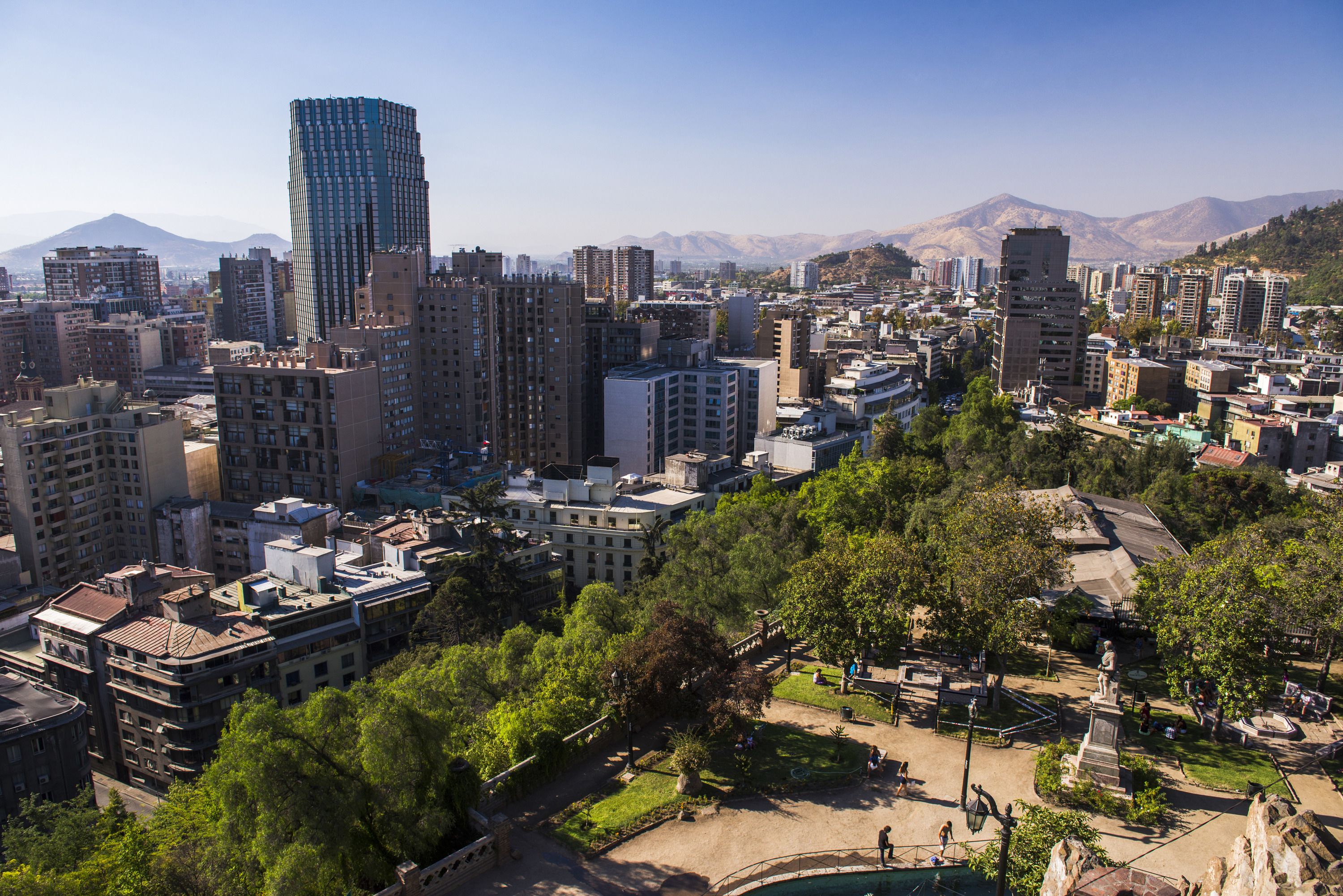 An aerial view of Parque Forestal, its river, trees and the city skyline stretching into the distance
