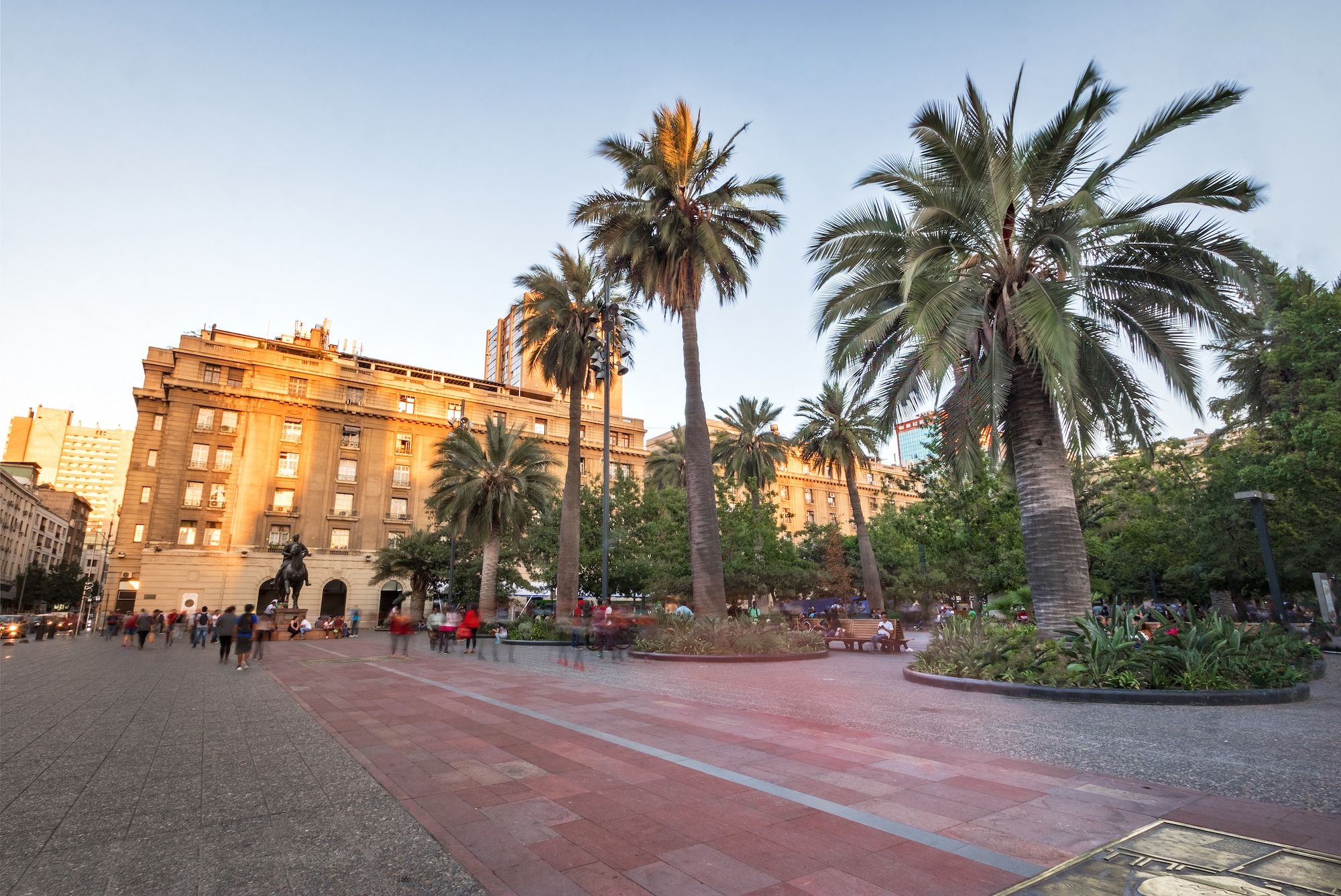 Tree-lined Plaza de Armas with the historic post office building and tall palm trees