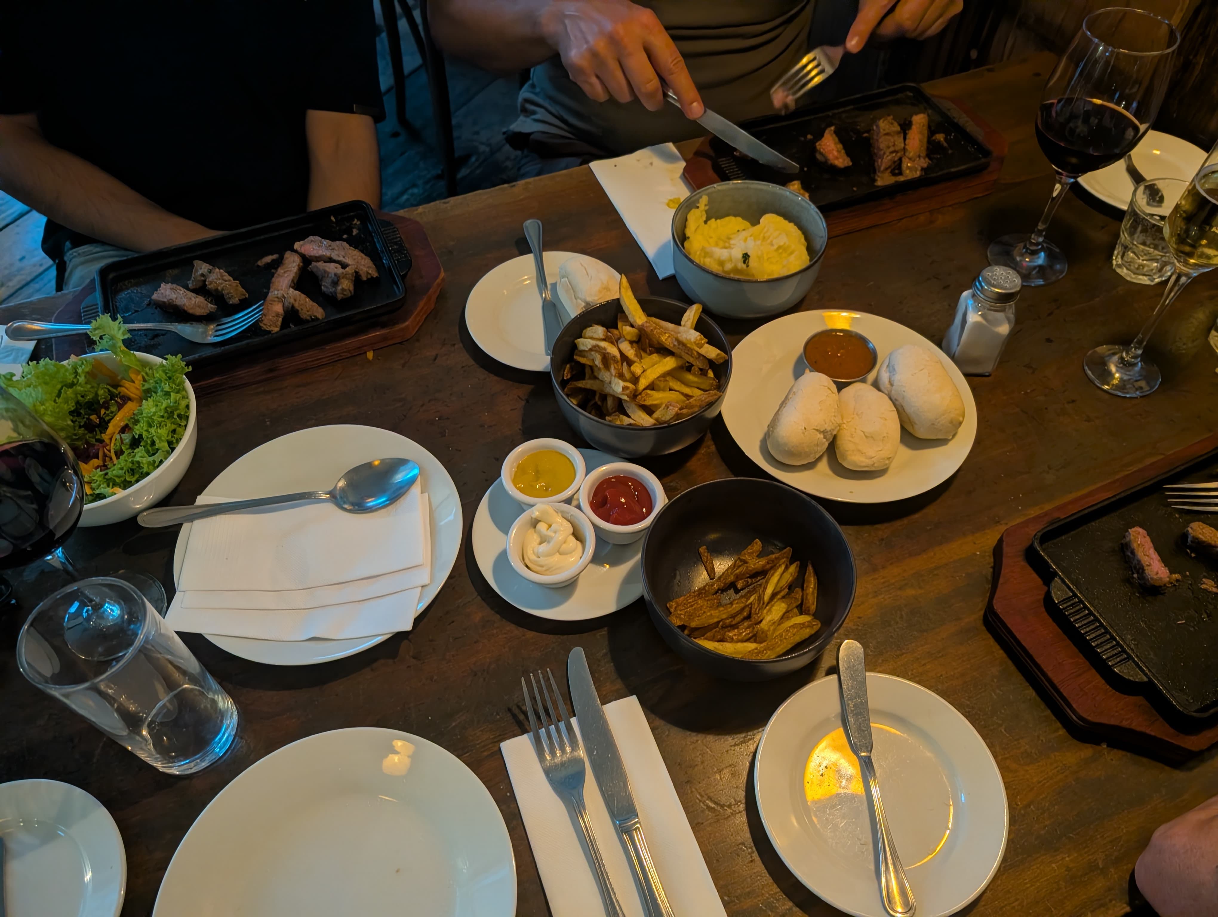 A spread of small plates and appetizers laid out across the table