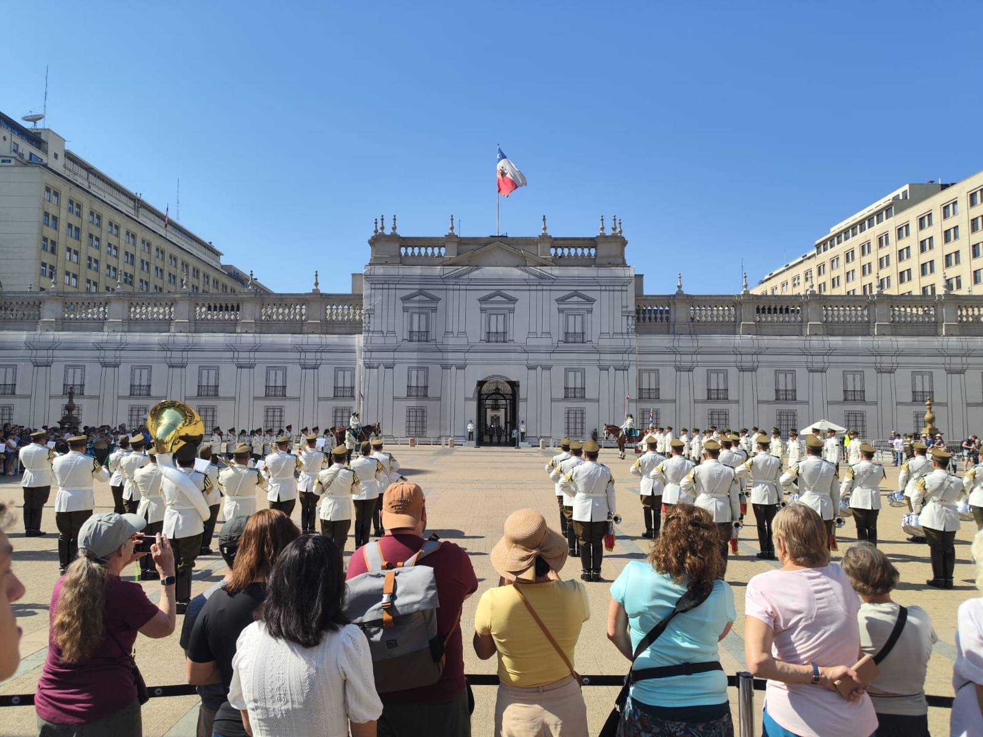The presidential band assembled in front of La Moneda palace while visitors watch from behind a railing