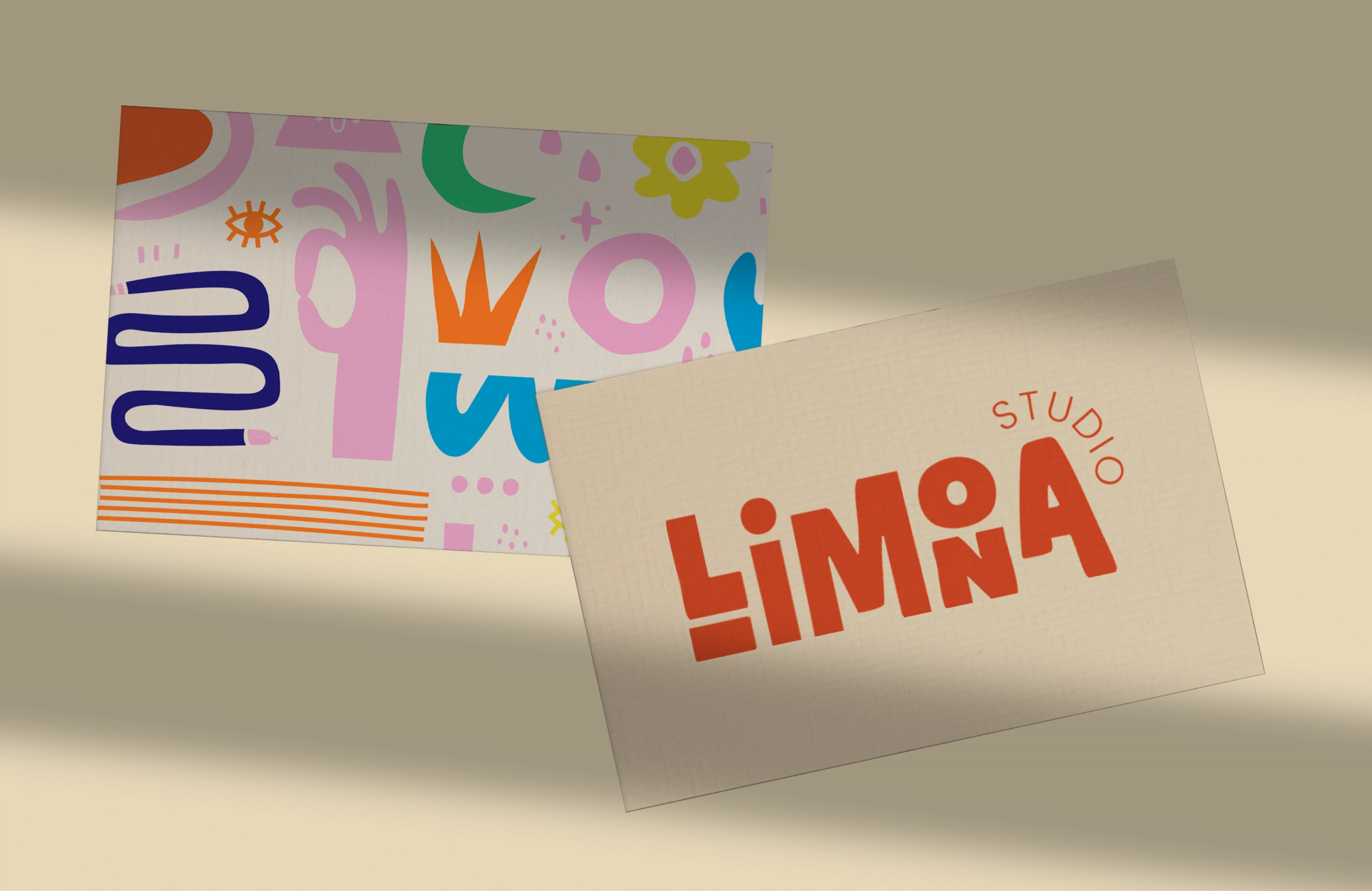Two Studio Limona business cards on beige, one with the orange logo, one covered in colourful shapes.