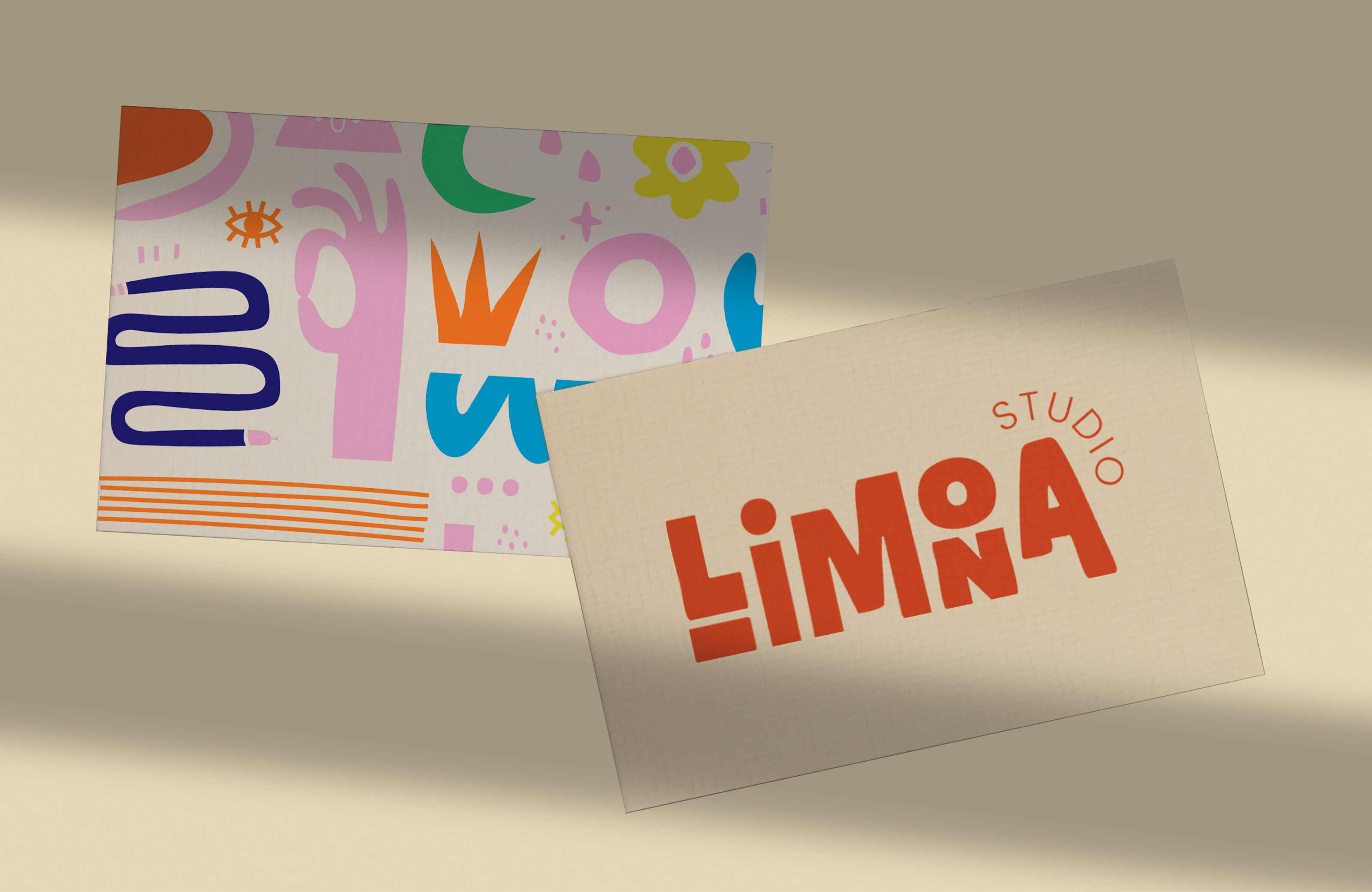 Two Studio Limona business cards on beige, one with the orange logo, one covered in colourful shapes.