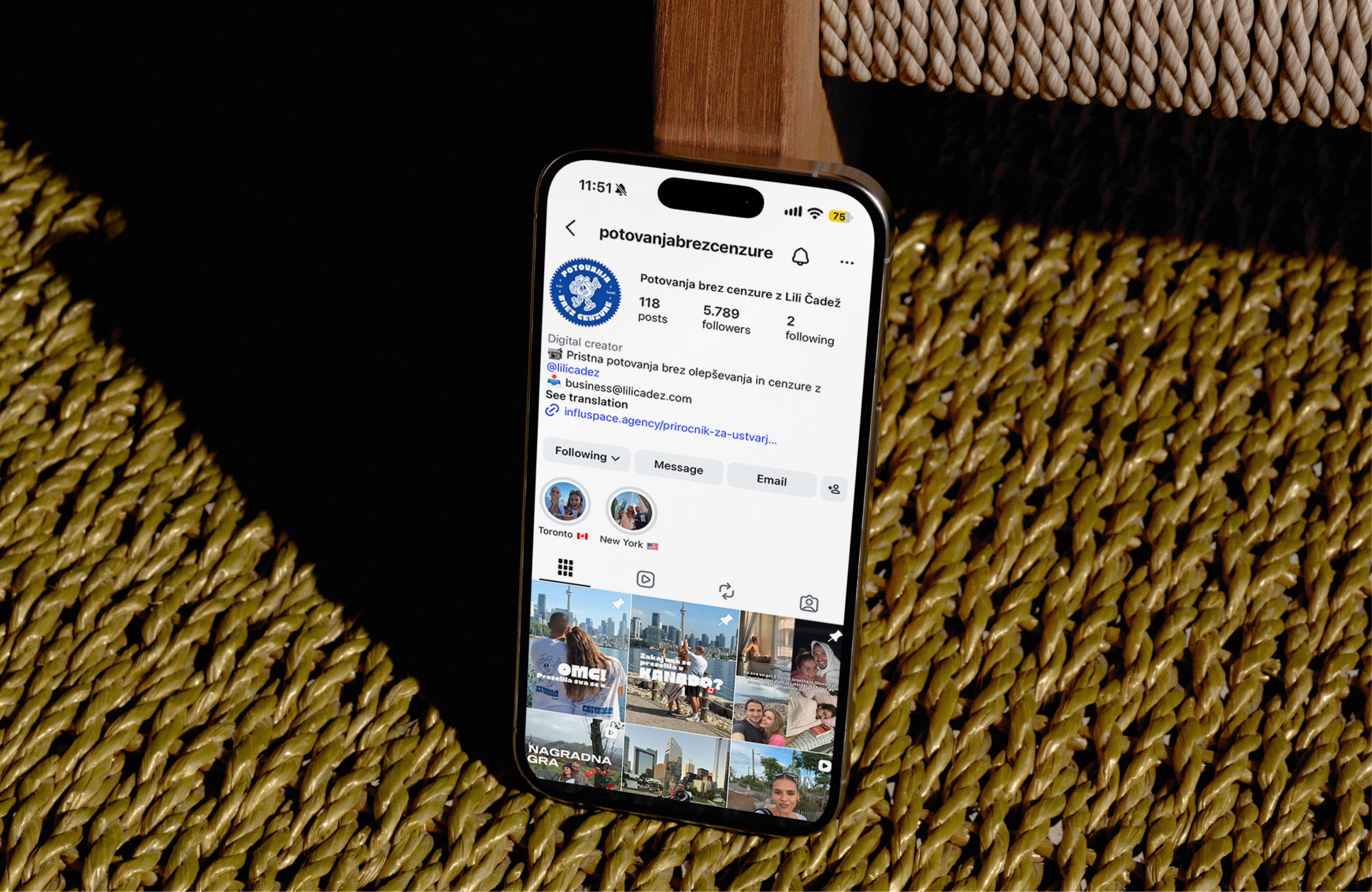 A phone on a woven seat, open on the potovanjabrezcenzure Instagram profile of travel photos.