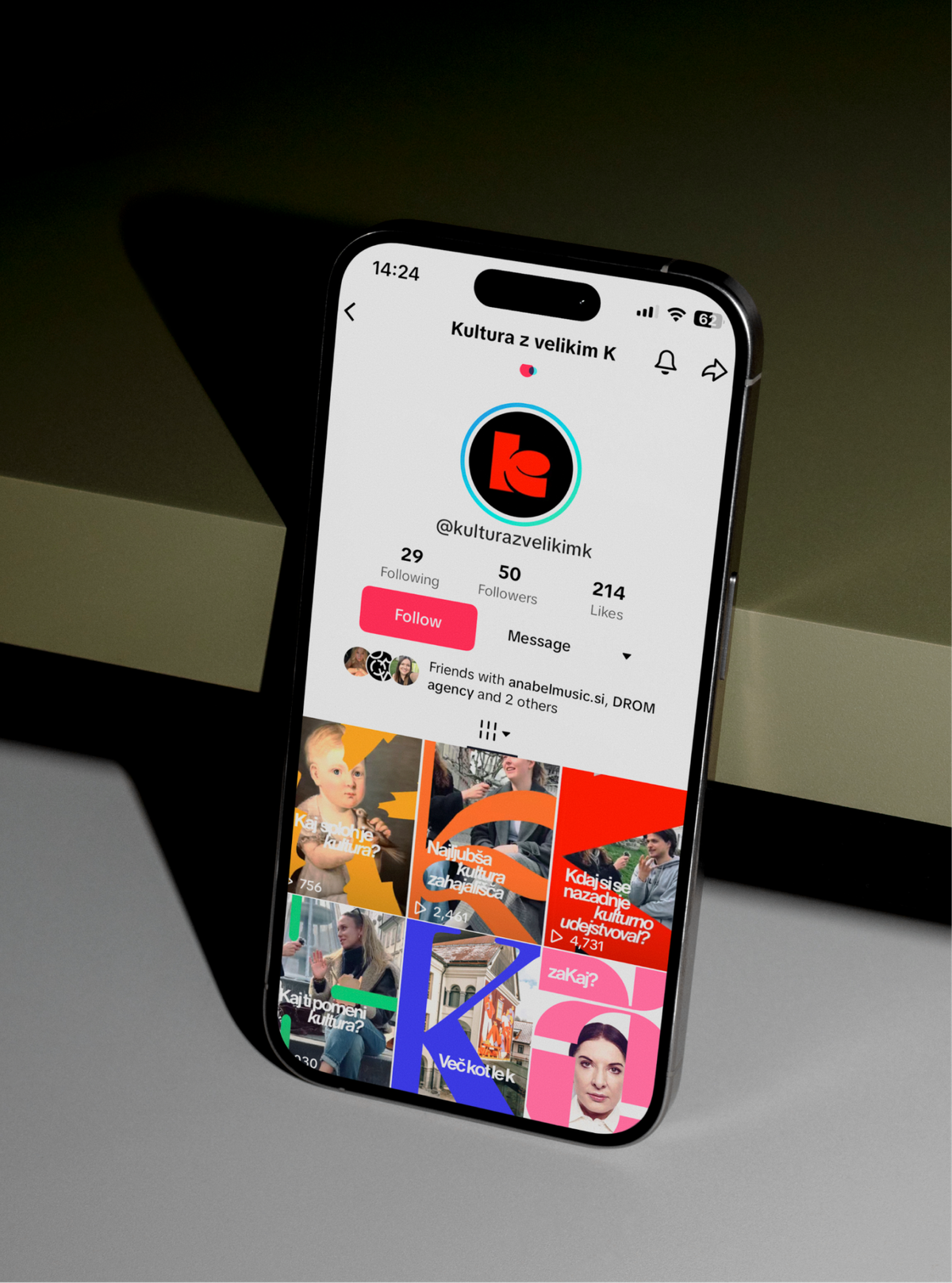 A phone leaning on a ledge, open on the @kulturazvelikimk TikTok profile with its red K avatar.