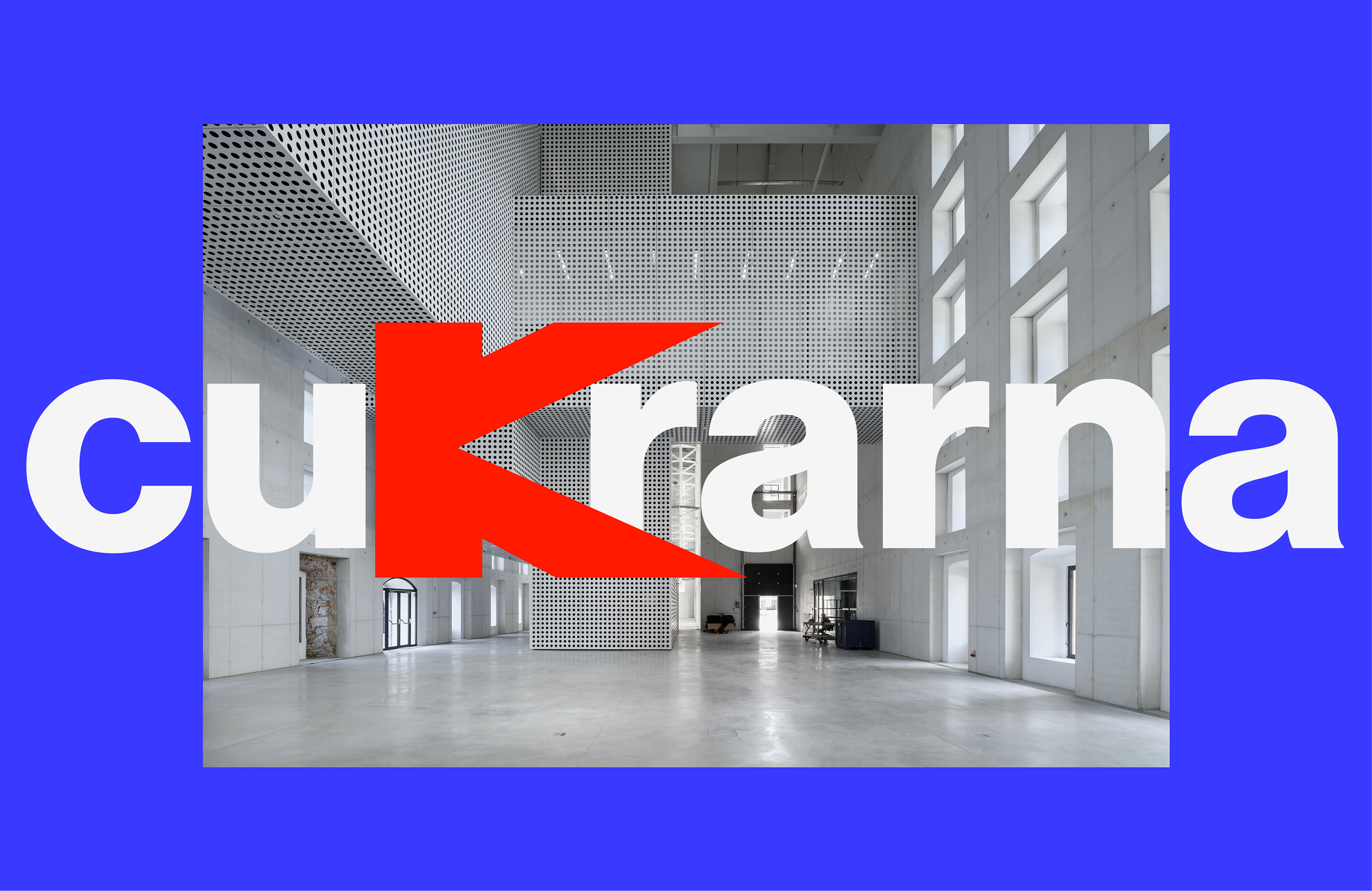 "Cukrarna" in white, its k a red block K, over the gallery's white concrete hall, framed in blue.