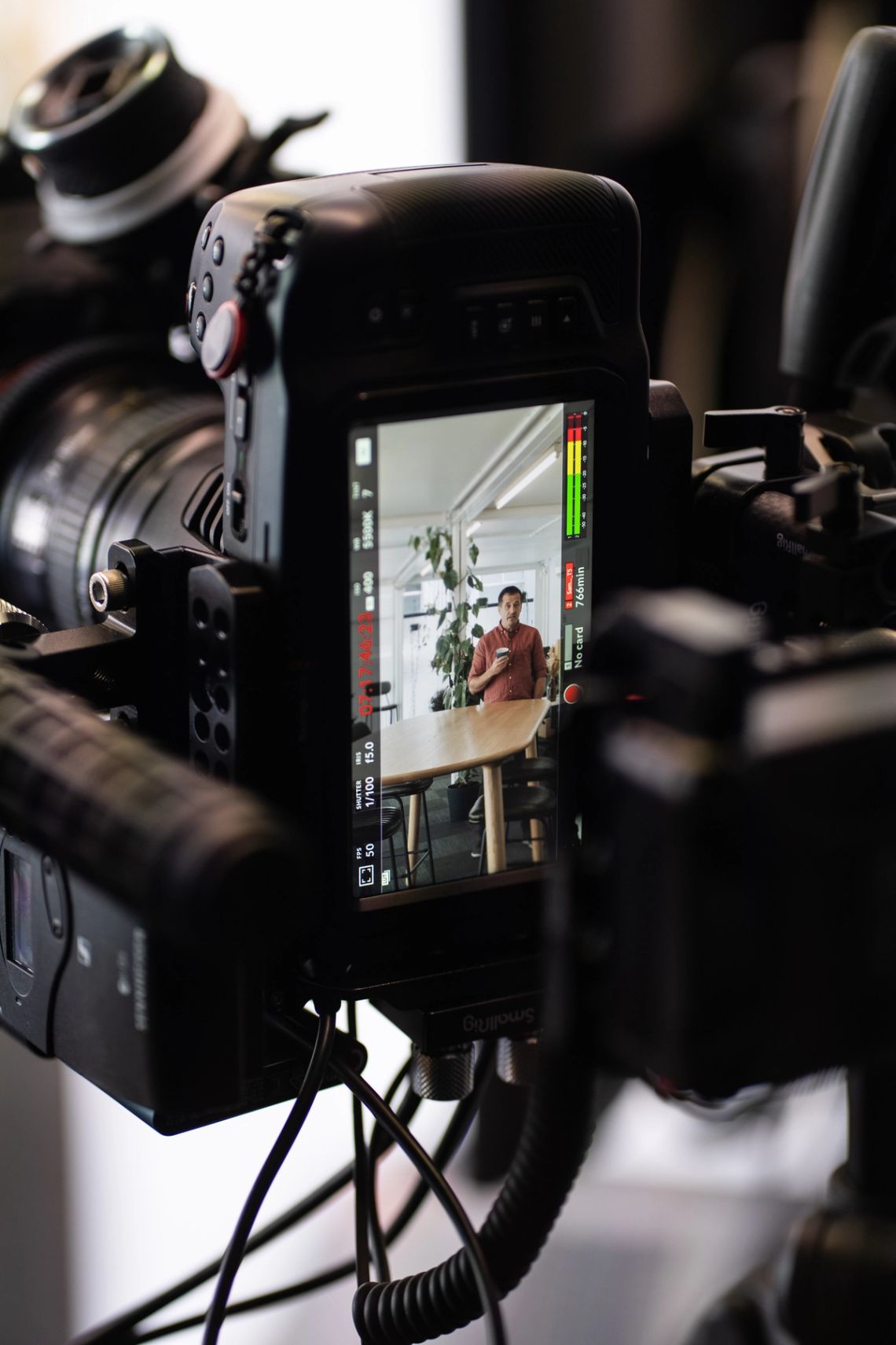 A cinema camera and its monitor filming a Done By Nine presenter in the studio