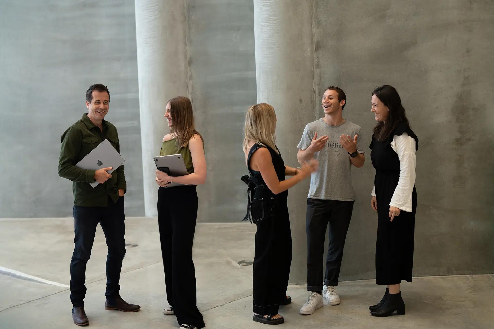 Six of the Done By Nine team talking together in the studio.