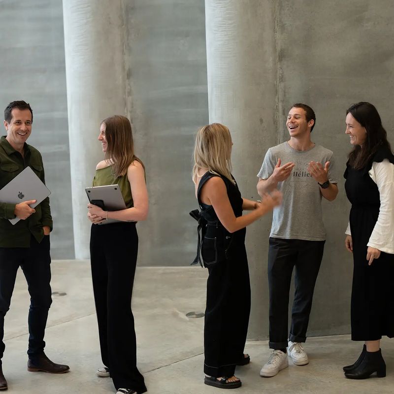 Six of the Done By Nine team talking together in the studio.