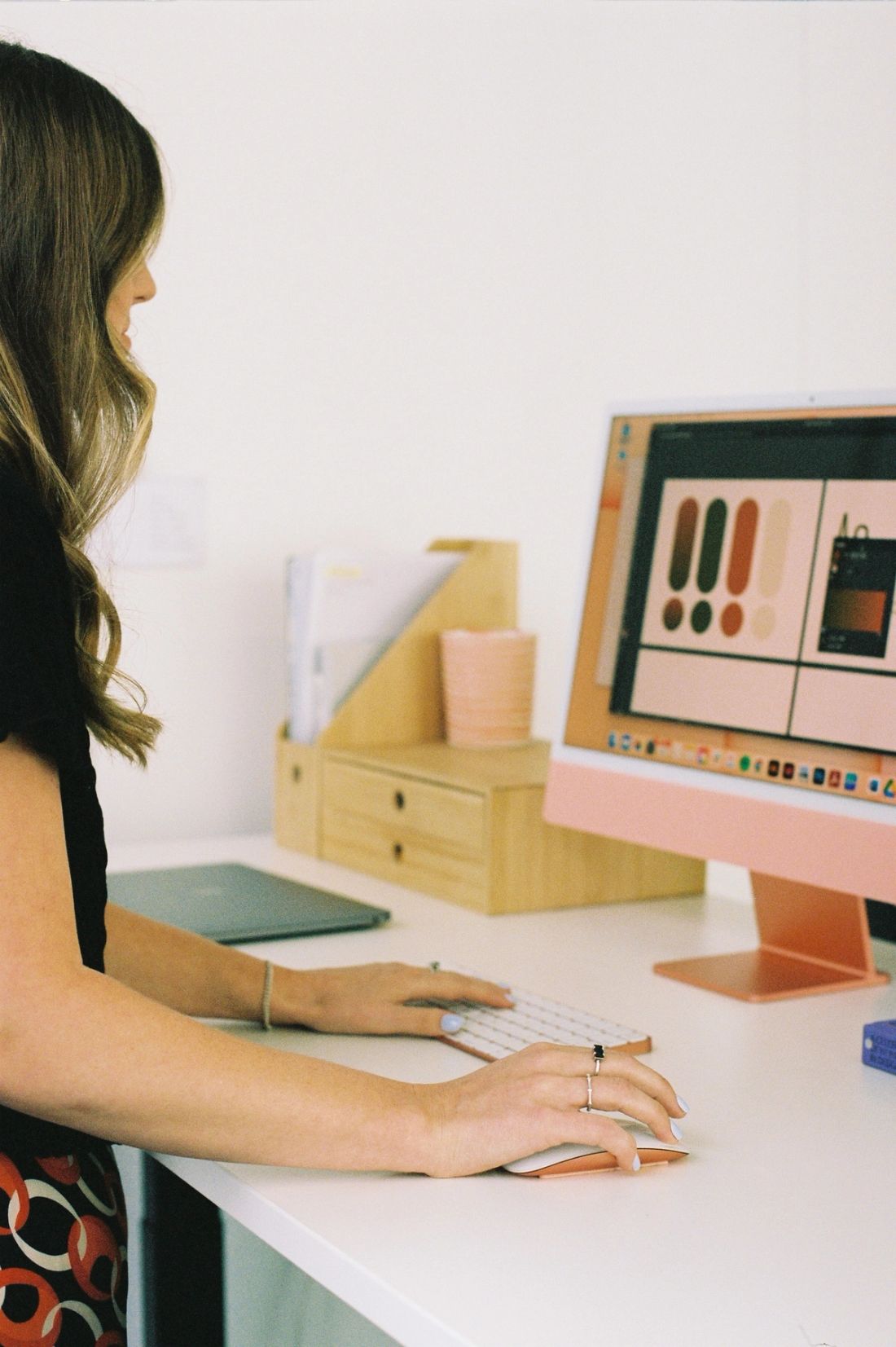 A brand colour palette open in design software on an iMac at a Done By Nine desk