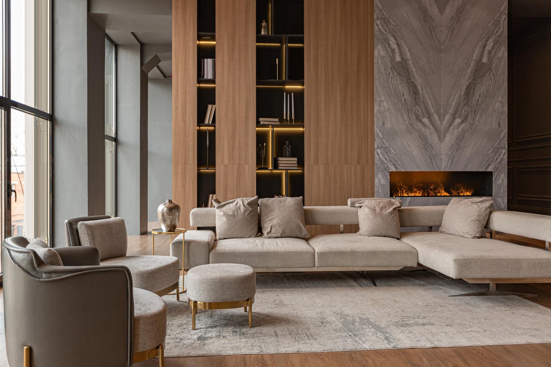 A tidy modern living room with a lit fireplace and wood shelving