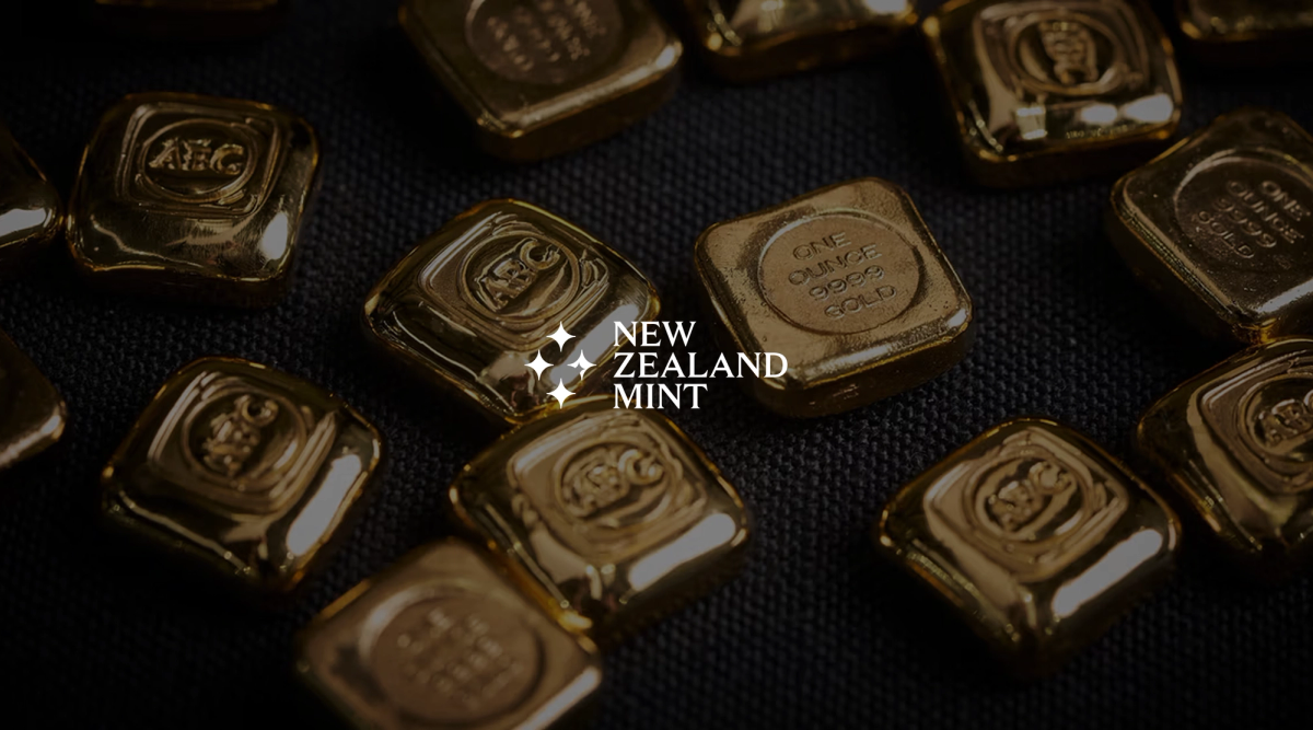 Scattered square gold bars with one-ounce markings on a dark background.