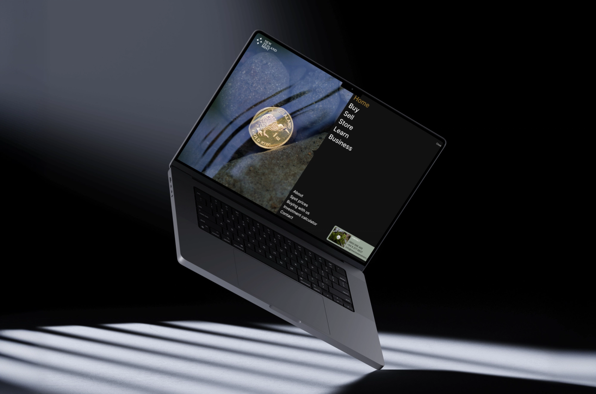 Angled laptop in darkness displaying a gold coin and website menu on its screen.