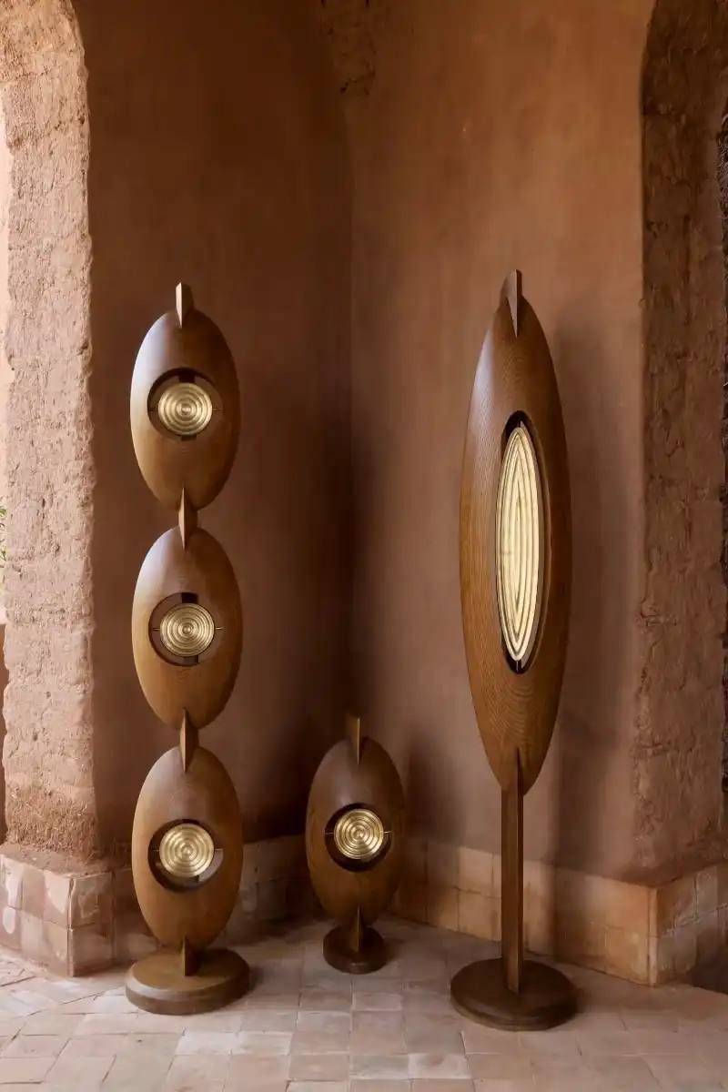 SALU IWADI GELEDE LAMP COLLECTION An image describing the Gelede lamp collection by Salu Iwadi Studio. The text details the materials and cultural meaning behind three lamp models.