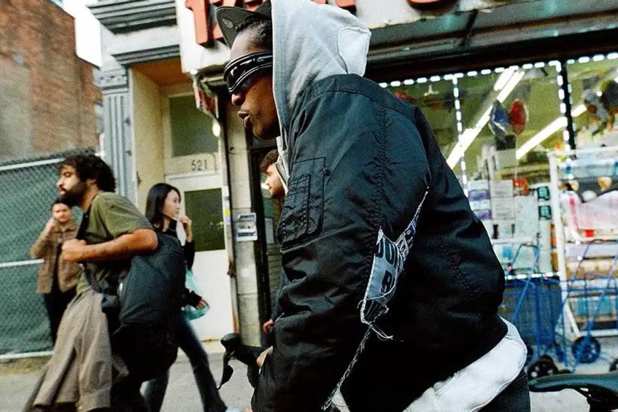 image about A$AP Rocky's new Ray-Ban sunglasses collection. The rapper, serving as Ray-Ban's Creative Director, has released three black sunglasses models called Ultra Wrap 001, 002, and 003. The frames were shown at his Paris Fashion Week runway show and are available on Ray-Ban's website.