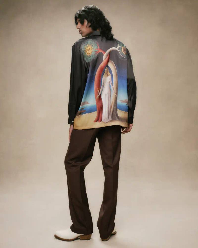 ANDERSON DUO LAUNCH LIMITED AW25 COLLECTION image about fashion designers Stevie and Alexandra Anderson releasing their Autumn/Winter 2025 collection. The collection features limited-edition garments with mythological and cosmic artwork, produced sustainably in Bali with organic fabrics and ethical practices. Each design is limited to under 100 pieces. The collection includes prints of dragons, jungle scenes, Greek gods, and folkloric spirits. Environmental initiatives include tree planting and zero-waste production. Prices start at £120 and the collection is available online.