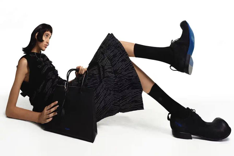ADER ERROR A fashion collection lookbook featuring minimalist designs that blend architectural silhouettes with subtle, intricate details. Garments in muted tones showcase complex knot work, layered textures, and geometric patterns that explore themes of memory and connection. Models wear carefully constructed outerwear, skirt sets, and tops that challenge traditional fashion boundaries.