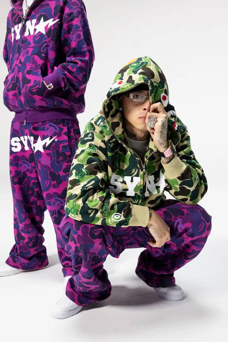 CENTRAL CEE DIRECTS BAPE SPOTIFY COLLECTION Central Cee BAPE Spotify SYNA collaboration streetwear collection featuring purple puffer jacket, football jersey, and graphic tees releasing November 25