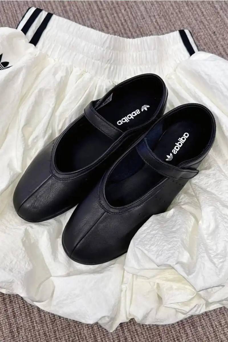 image about leaked photographs of upcoming adidas Stan Smith Ballet shoe featuring flat sole construction, minimalist design elements, single leather strap closure system, and expected summer 2025 release in black and white colorway options.