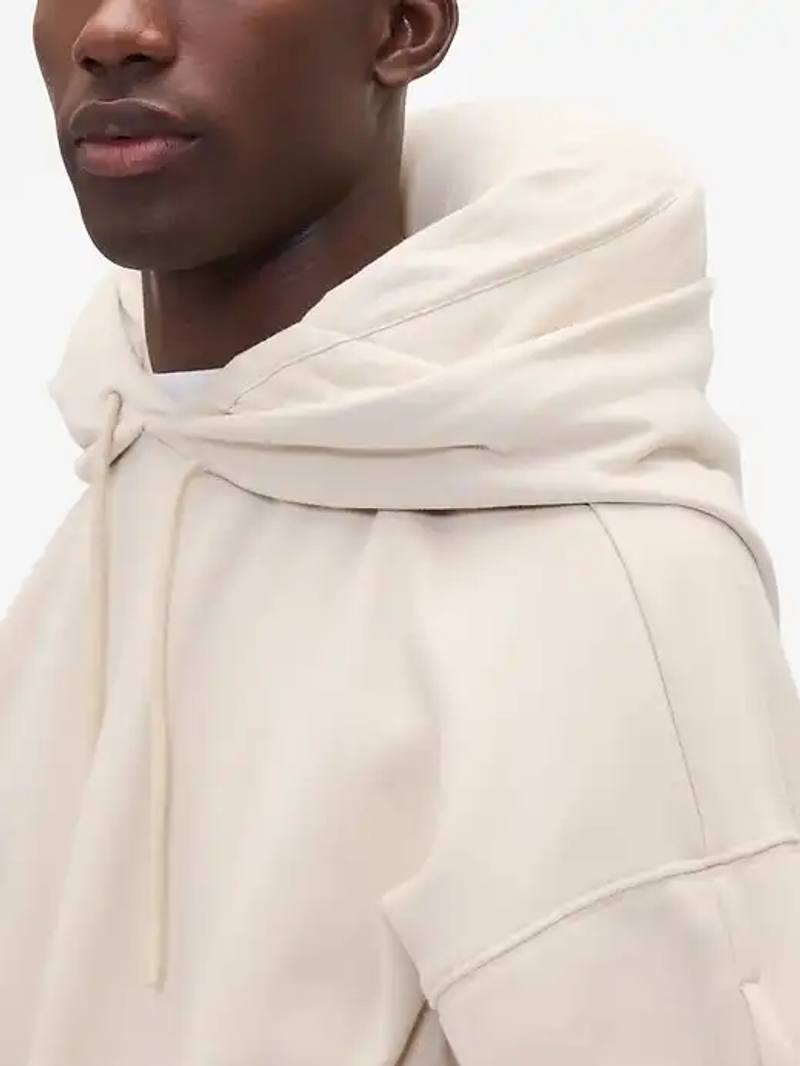 image about Gap's new travel hoodie with inflatable hood feature that serves as a neck pillow.