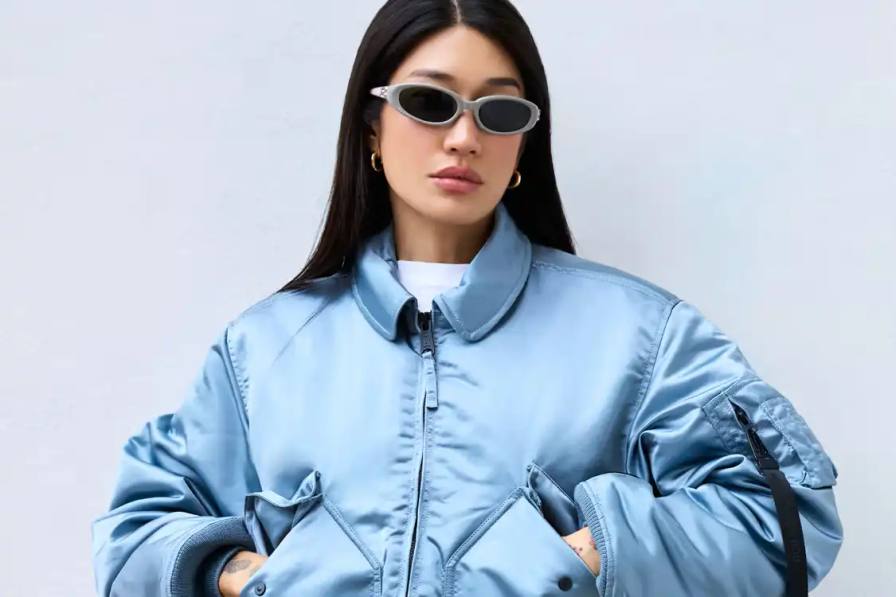 ALPHA INDUSTRIES X PEGGY GOU COLLECTION image about Alpha Industries and Peggy Gou's collaborative clothing collection, featuring bomber jackets and a versatile wrap skirt designed for transitioning between different environments.