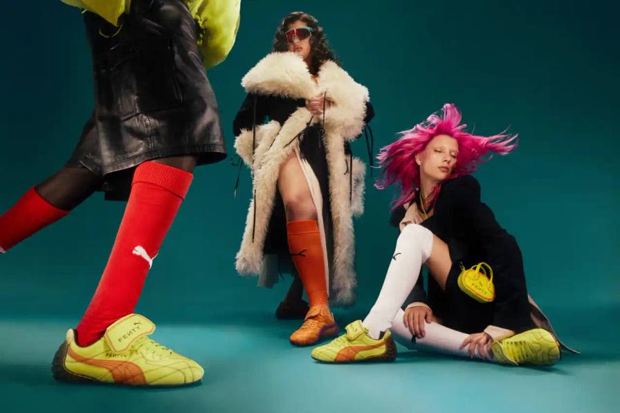 FENTY x PUMA launches neon-colored Avanti LS sneakers, Cat Cleat Jelly slides, and Pocket Bags. Available worldwide March 13 in yellow and orange.