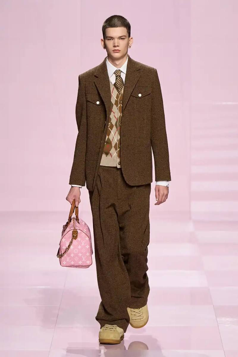 Louis Vuitton's Fall/Winter 2025 menswear collection, detailing the creative collaboration between Pharrell Williams and NIGO, featuring streetwear elements, Japanese craftsmanship, and French luxury design, with references to historical brand elements and new patterns.