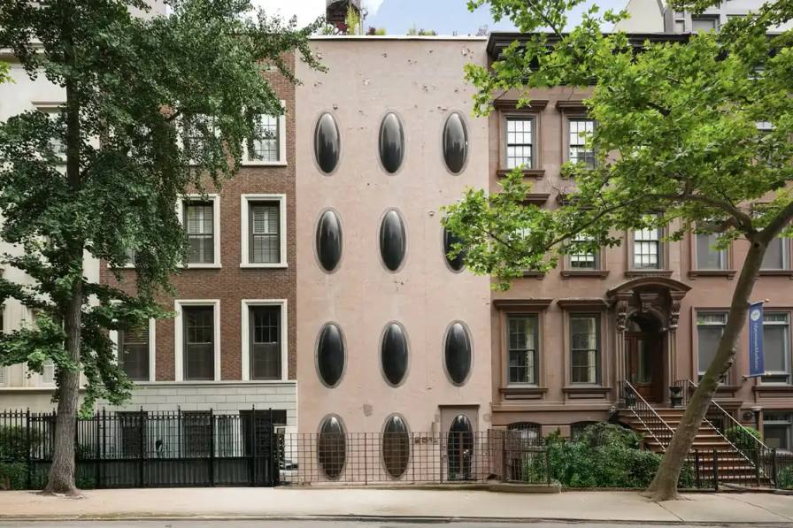 image about a unique Manhattan townhouse featuring circular windows, designed by architect Maurice Medcalfe in 1969, now for sale at $5.75 million. Includes property details, architectural history, and neighborhood context.