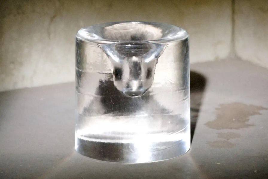 Clear crystal Palo Santo holder by 6:AM Glassworks, showing circular cavity in 8cm glass form.