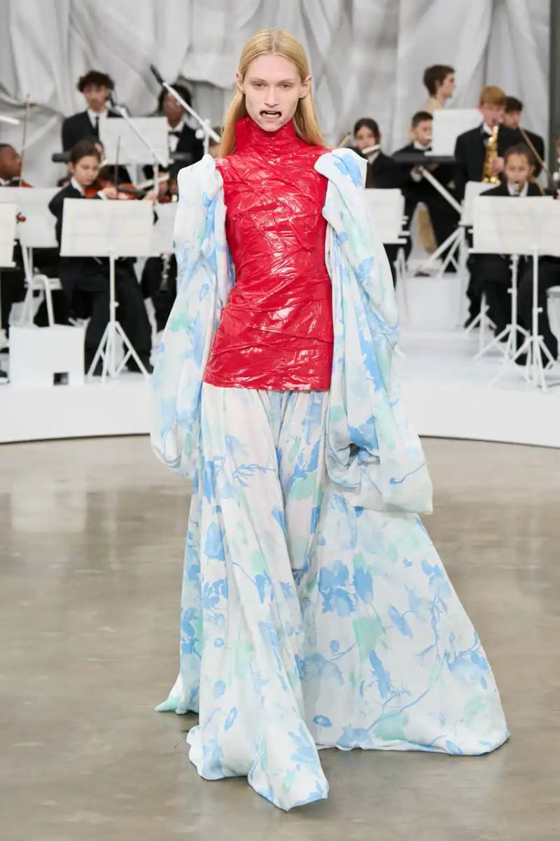 Review of Glenn Martens' first co-ed ready-to-wear collection for Maison Margiela Spring Summer 2026, featuring new tailoring techniques, upcycled materials, and distinctive silhouettes.