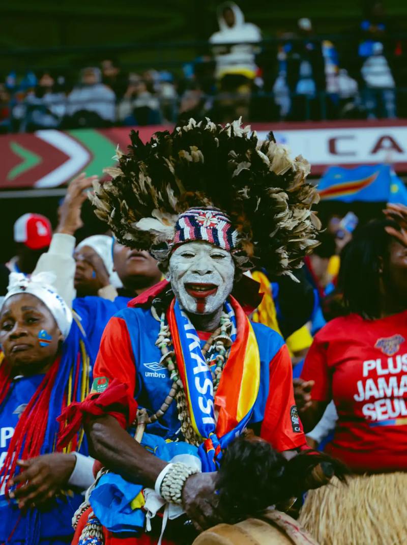 Image photographs by Miguel the Colored Cowboy capture AFCON 2025 supporters in streets and stadiums. Images show clothing worn with purpose. Jerseys, tailored pieces, traditional fabrics, and sportswear appear across the frames. Faces show tension, pride, and focus. Clothing looks lived in. Scarves, jackets, and footwear respond to weather and movement. No staging. No distance. The gallery documents how style serves the moment during match days. Each image places viewers inside the crowd where expression stays personal and presence stays shared.