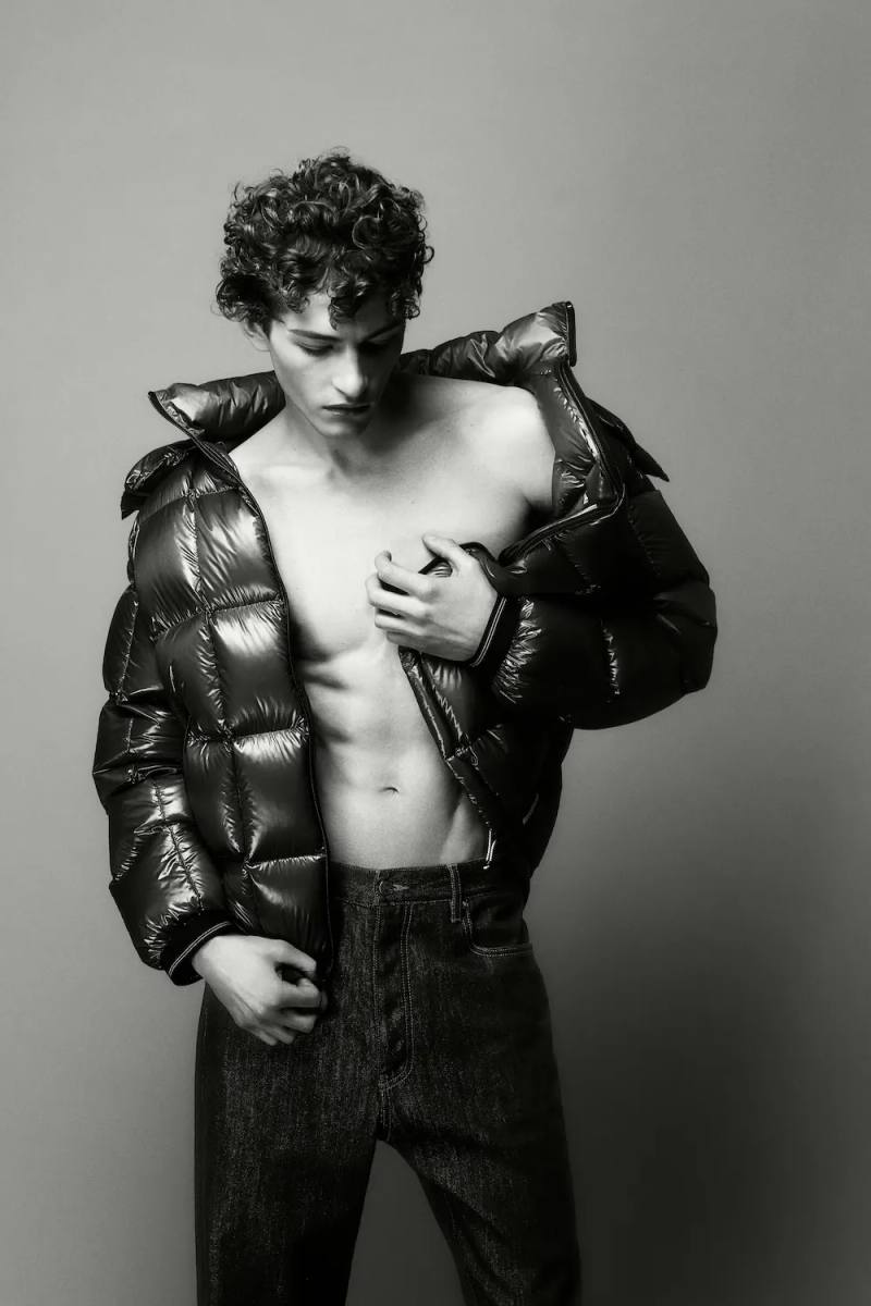 Black and white portrait photography from the Armani Exchange Basics campaign set against a neutral studio background.