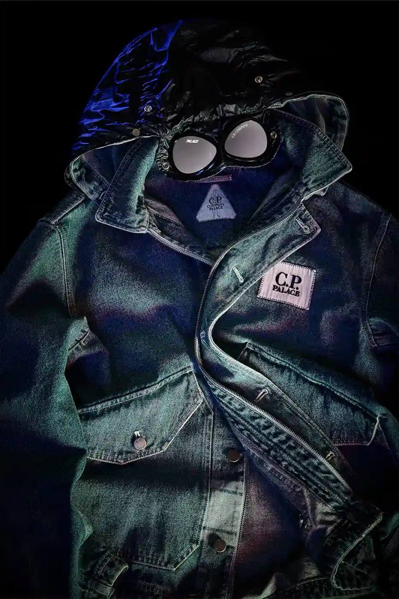 A fashion collaboration between Palace and C.P. Company. It details the "C.P. Palace" capsule collection featuring the Goggle Jacket, denim pieces, and various apparel in blue and khaki colors. The article provides information about the collection's availability starting March 28 at C.P. Company and Palace stores in multiple cities, plus a special pop-up at Dover Street Market Paris from March 28-30.