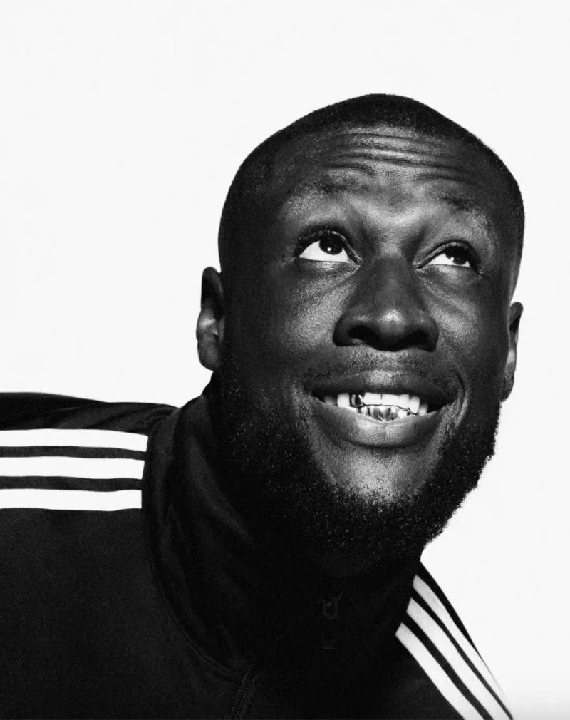 ADIDAS SUPERSTAR CAMPAIGN STARS STORMZY, BELLINGHAM, KEOGHAN image covers Adidas campaign featuring celebrities wearing iconic Superstar sneakers and Firebird tracksuits in black and white photography.