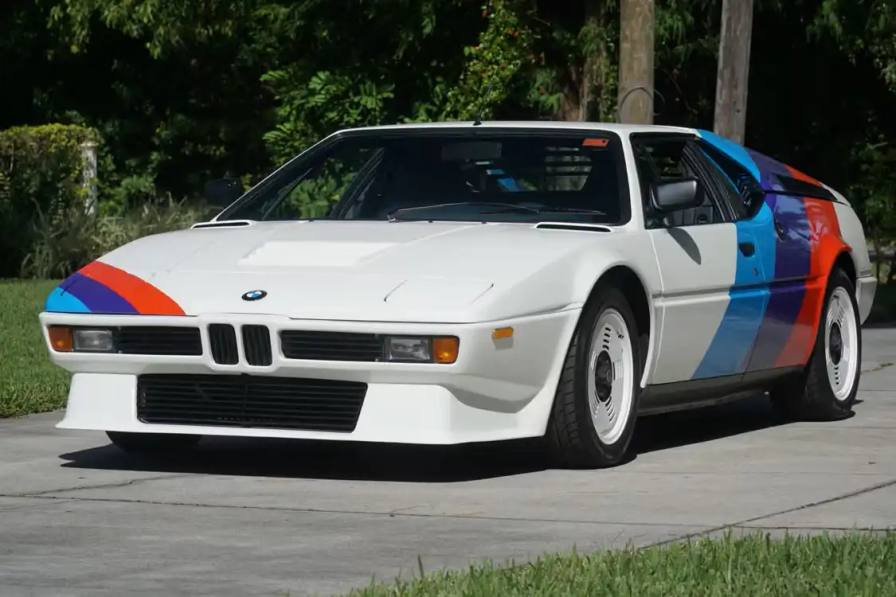 Article about the auction of a 1980 BMW M1 awarded to Formula 1 driver Niki Lauda, featuring details about the car's history, specifications, and estimated value.