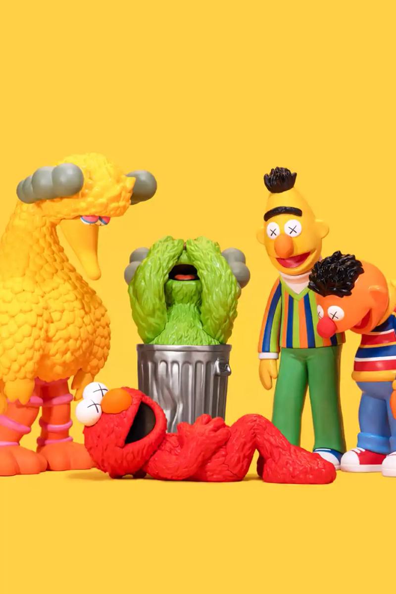 image about new KAWS and AllRightsReserved collaboration featuring Sesame Street character vinyl figures with distinctive X-eyes aesthetic, available for pre-order October 16.