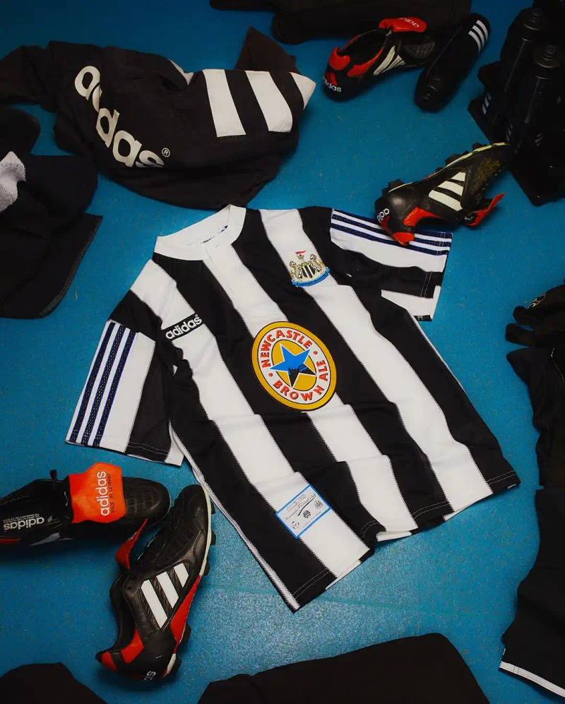 Newcastle United 1995-96 home shirt remake featuring black and white stripes, Henley collar, adidas trefoil logo, and Newcastle Brown Ale sponsor