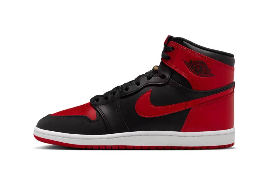 Air Jordan 1 Hi '85 'Bred' sneaker in black and red leather with white midsole. Features original 1985 specifications including modified Swoosh shape, compact Wings logo, and elevated collar height. The shoe has a black leather base with red leather overlays, white Nike Swoosh, and red rubber outsole.