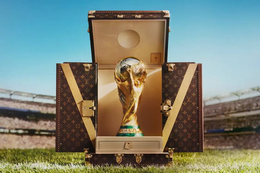 An image of the custom Louis Vuitton Trophy Trunk for the 2026 FIFA World Cup, featuring the classic Monogram canvas and brass hardware.