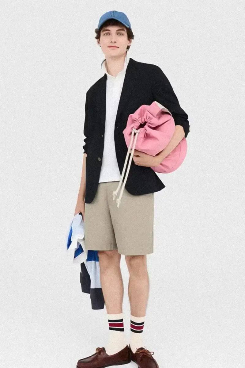 Uniqlo Models wearing Uniqlo x JW Anderson SS25 collection pieces, including blazers, button-ups, and casual wear in neutral tones against a white background
