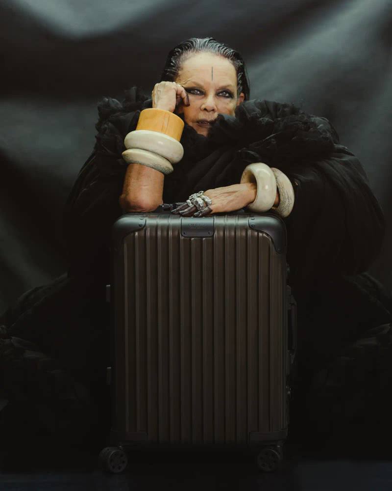 RIMOWA x Rick Owens bronze aluminum cabin suitcase with dark metallic finish and black leather details against neutral background