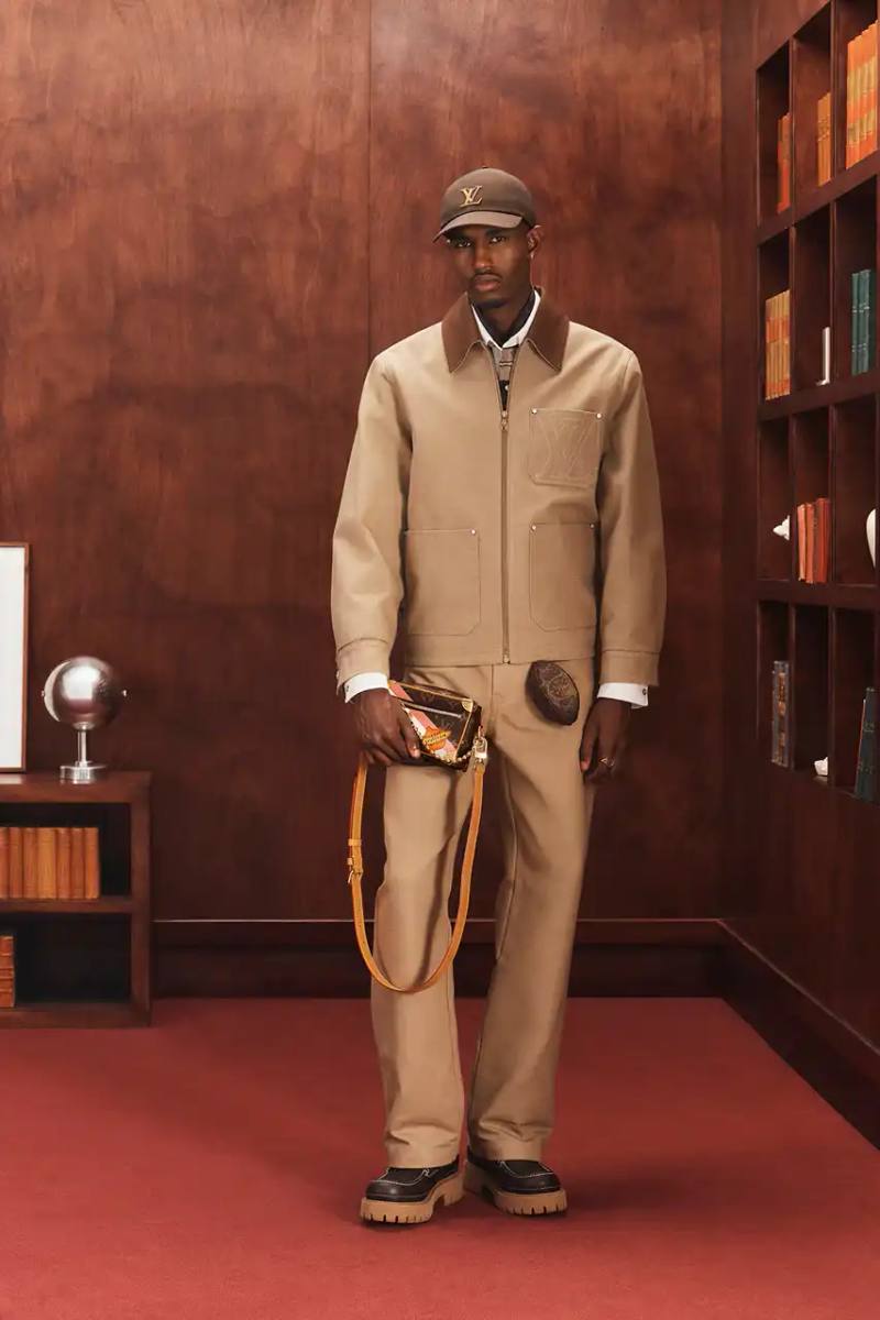 LOUIS VUITTON FALL 2026 MENSWEAR PREVIEW image about Louis Vuitton's upcoming Fall 2026 menswear collection designed by Pharrell Williams. The piece discusses the collection's American collegiate inspiration, key design elements including tartan patterns and heritage stripes, outerwear focus, and September release timeline. Contains detailed descriptions of clothing items, patterns, materials, and accessories without accompanying images.