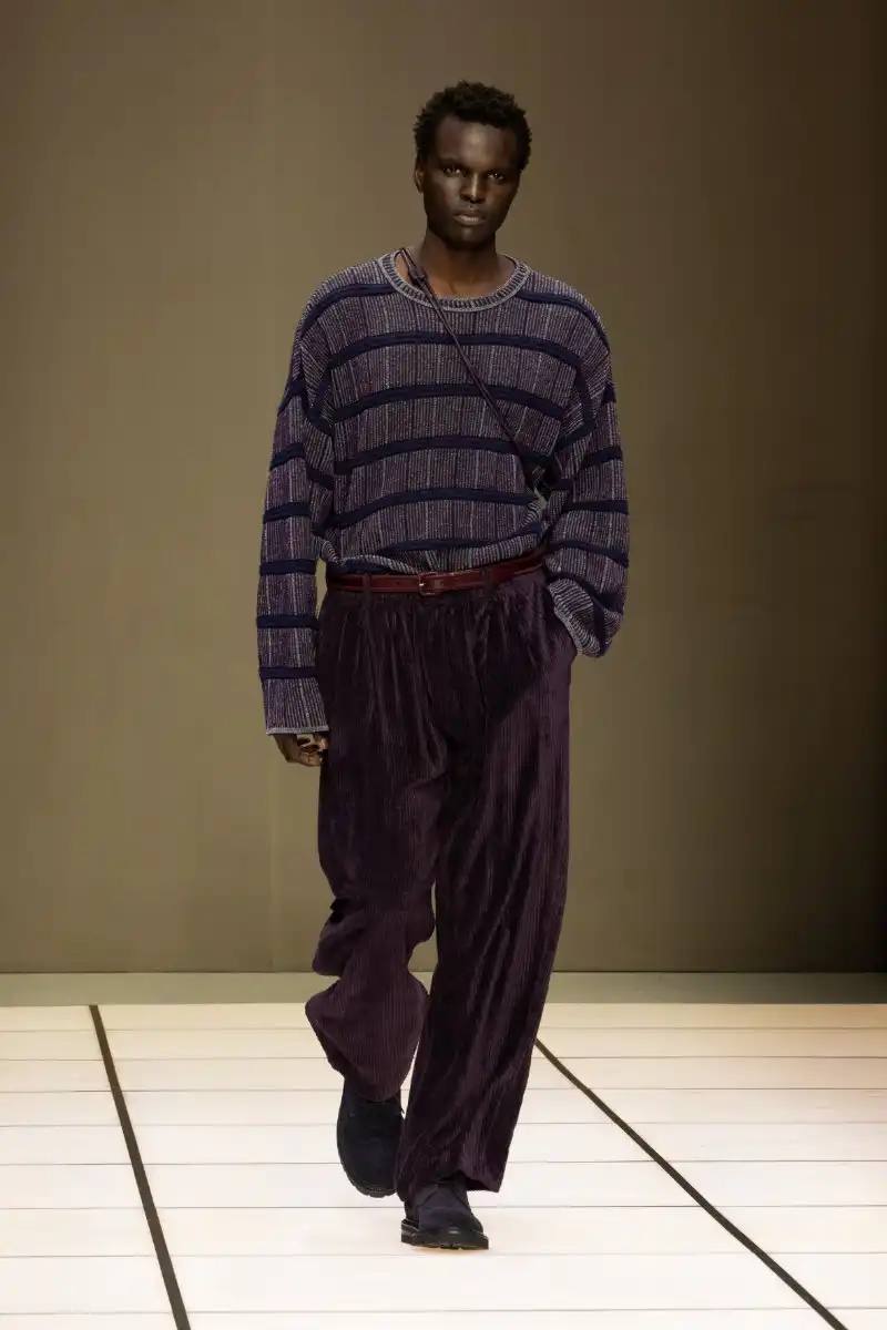 Giorgio Armani Fall/Winter 2026 collection debut by Leo Dell'Orco at Milan Fashion Week features iridescent colors and fluid silhouettes.
