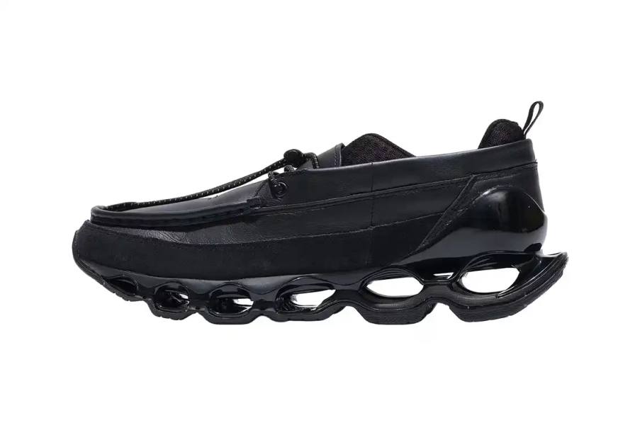 Image shows the Mizuno WAVE PROPHECY MOC sneaker in an all-black colorway featuring leather upper construction, U-shaped moccasin stitching, and the brand's Infinity Wave plate technology.