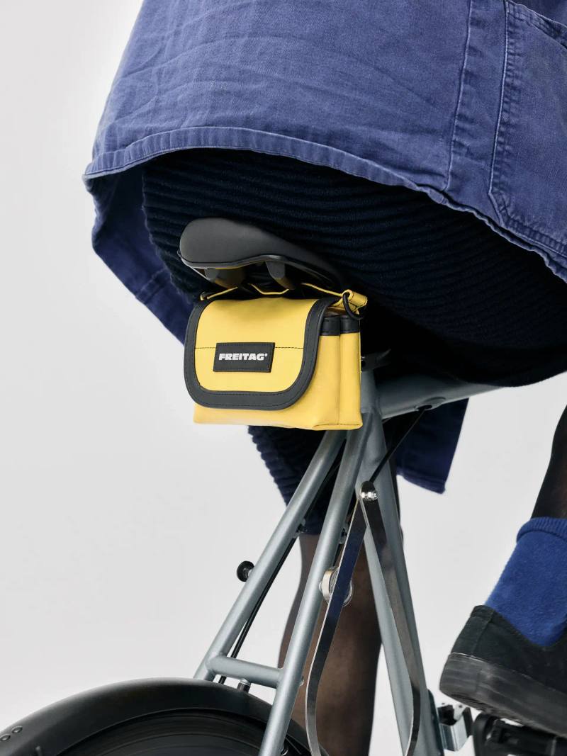 An image detailing three new Freitag bags designed for bicycles featuring recycled truck tarpaulins and reflective elements.
