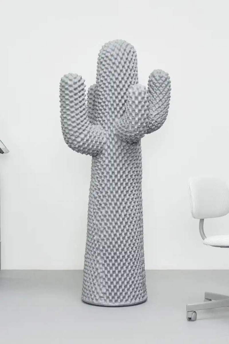 The BORING CACTUS® by Gufram, a life-size gray coat stand in the shape of a stylized cactus with four extending arms. The surface is covered in thousands of small nodules, and the piece stands 170 centimeters tall against a neutral background.