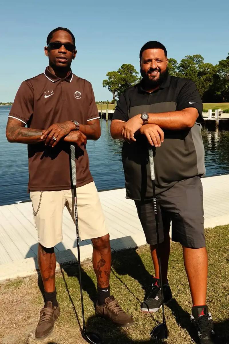 Travis Scott & Dj Khaled playing golf wearing a brown Dark Mocha polo with Cactus Jack and Nike logos during Reggie Jackson's Celebrity Golf Classic