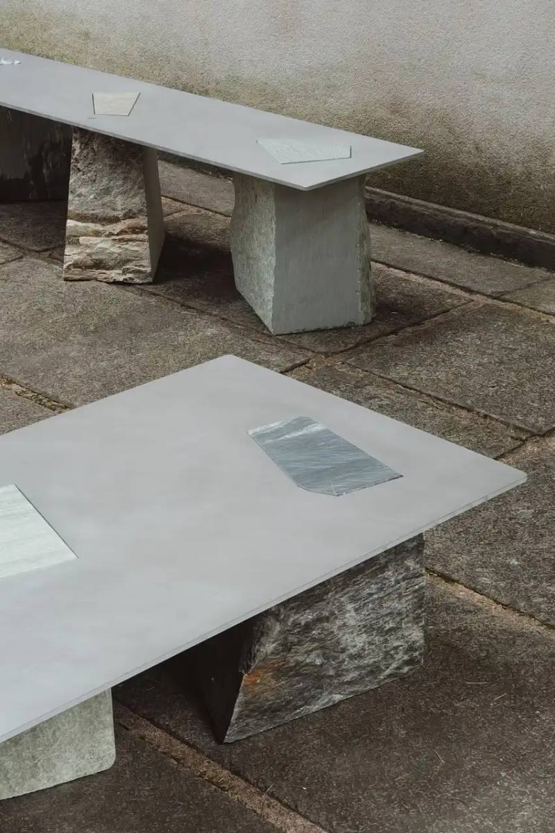 FROM QUARRY WASTE TO DESIGN TREASURE: ESTUDIO MATERIAL'S LATEST COLLECTION This article covers Estudio Material's FRAGMENTS MILANO furniture collection exhibited at Milan Design Week. Designer Damaso Mayer repurposed stone waste from Italian quarries in collaboration with Sacco Natural Stone. The collection features tables, benches and a sculptural tower that combine rough stone edges with smooth aluminum surfaces, creating a visual contrast inspired by Italy's natural landscape. The exhibition continues Mayer's ongoing work with local stone remnants and can be viewed at Villa Borsani until April 13.