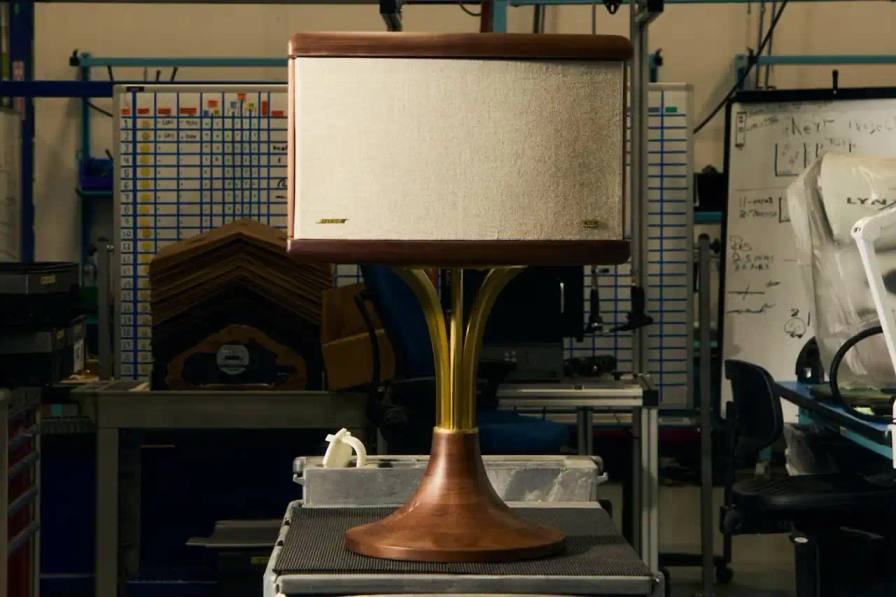 Image of a Kith x Bose 901 limited edition speaker, featuring a sleek midcentury modern design with wood base and brass accents, showcasing a vintage audio system reimagined through contemporary craftsmanship.