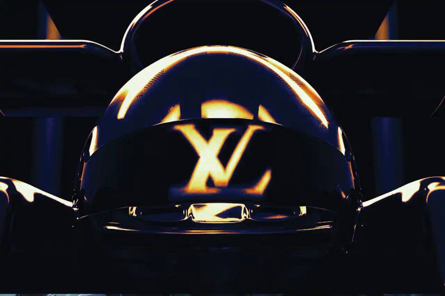 LOUIS VUITTON SIGNS DECADE-LONG FORMULA 1 PARTNERSHIP A Formula 1 race car on track with Louis Vuitton branding visible on trackside barriers and a decorative Louis Vuitton monogram Trophy Trunk displayed on the winner's podium.