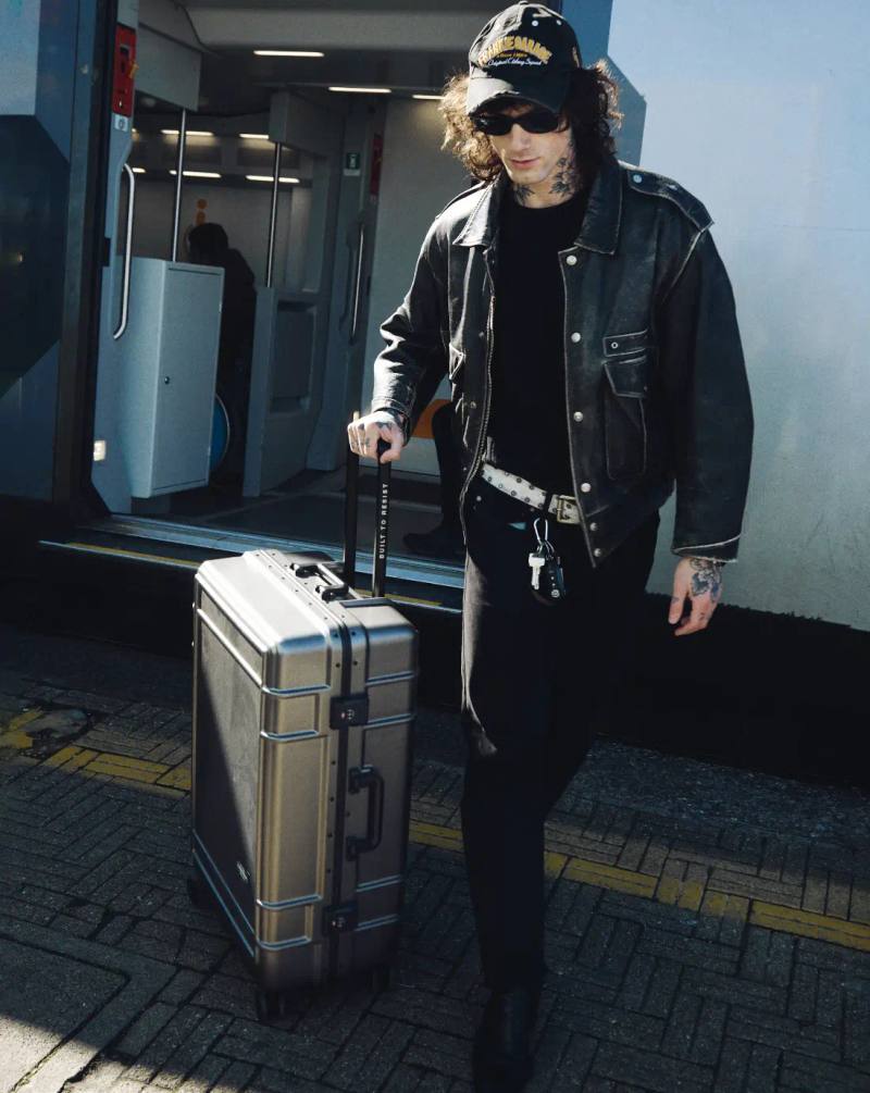 CREATIVITY IN MOTION WITH STYLIST FRANCESCO MAUTONE Stylist Francesco Mautone carrying an Eastpak bag while walking through a modern hotel lobby, representing creativity in motion. Photography by Simone Paccini